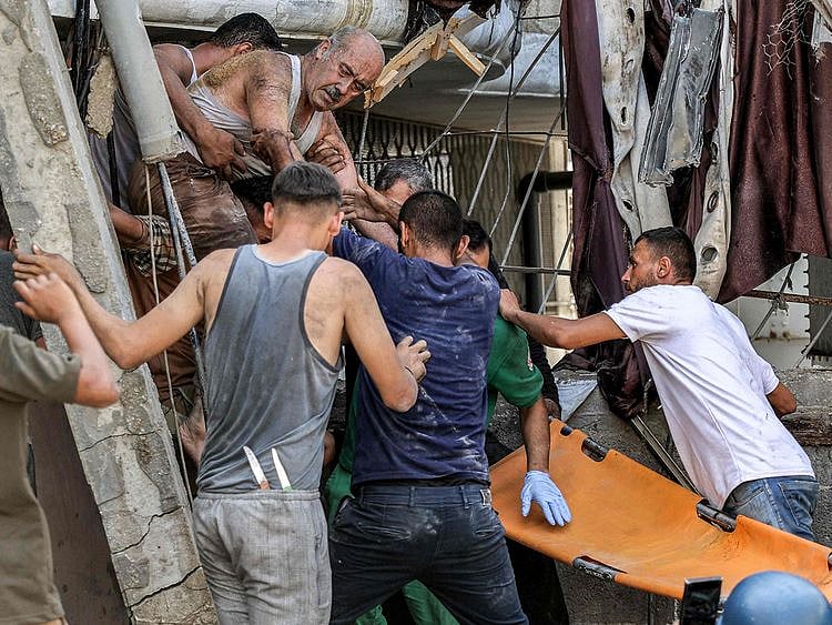 A man is extricated from the rubble of a collapsed building following Israeli bombardment after his rescue in the Saftawi district in Jabalia in the northern Gaza Strip on October 15, 2024.