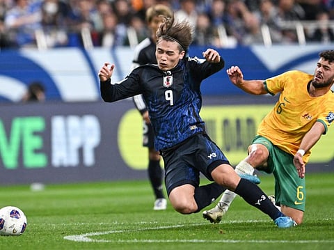 Japan's Ayase Ueda (left) and Australia's Patrick Yazbek compete for the ball during the Fifa World Cup 2026 Asian zone qualifiers football at Saitama Stadium in Saitama on Tuesday.