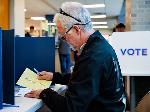 Michael Hoy, 66, votes using an absentee or mail-in ballot on October 15, 2024 in Doylestown, Pennsylvania.