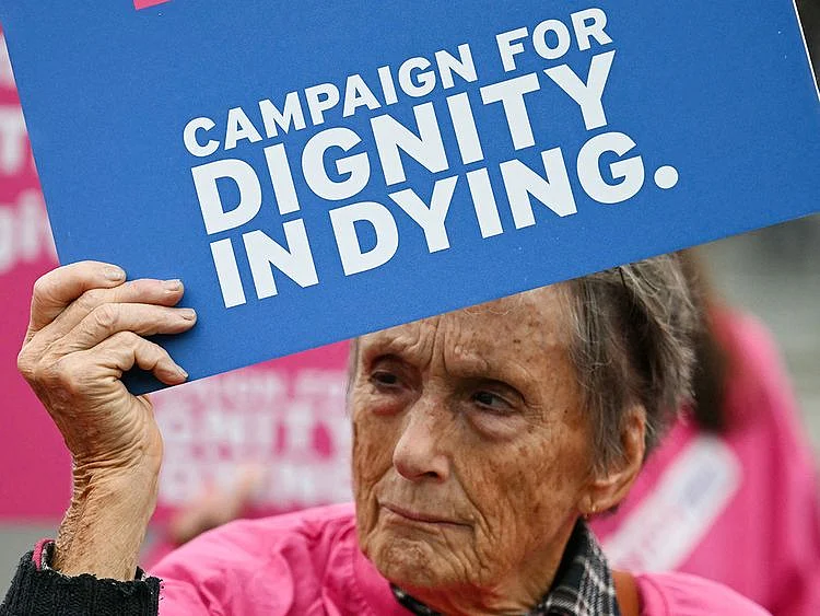 A campaigner from "Dignity in Dying" hold a placard