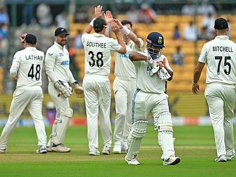 New Zealand's players celebrate after the dismissal of India's Rishabh Pant during the second day of the first Test cricket match at the M. Chinnaswamy Stadium in Bengaluru on Thursday.