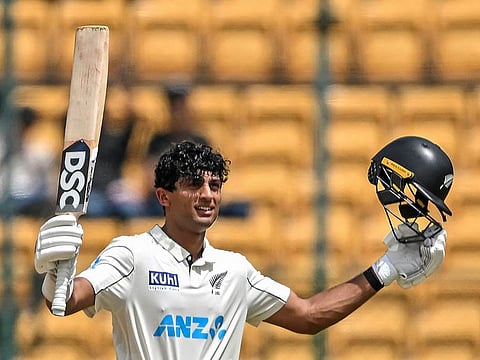 New Zealand's Rachin Ravindra celebrates after scoring a century during the third day of the first Test against India in Bengaluru.
