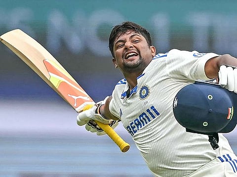 India's Sarfaraz Khan celebrates after scoring a century (100 runs) during the fourth day of the first Test cricket match between India and New Zealand at the M. Chinnaswamy Stadium in Bengaluru on October 19, 2024