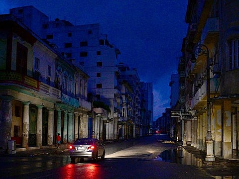 A car drives along a street during a nationwide blackout caused by a grid failure in Havana, on October 19, 2024.