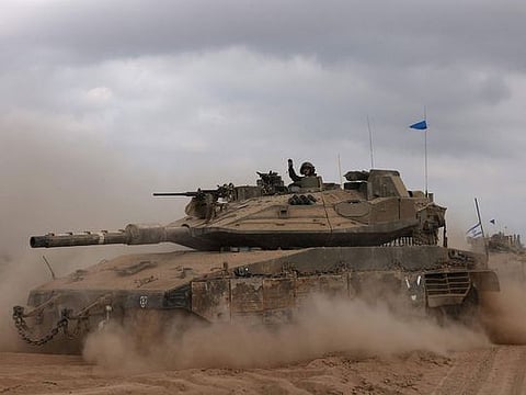 An Israeli army tank drives in an area near Israel's southern border with Gaza 