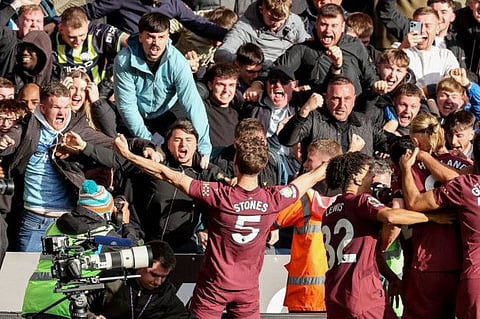 Manchester City's English defender John Stones celebrates scoring the team's second goal during the English Premier League football match against Wolverhampton Wanderers at the Molineux stadium in Wolverhampton on Sunday.