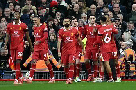 Liverpool's English midfielder Curtis Jones (3L) celebrates scoring the team's second goal during the English Premier League football match against Chelsea at Anfield in Liverpool, north west England on Sunday.