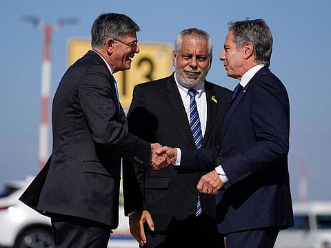 US Secretary of State Antony Blinken (R) is greeted by US Ambassador to Israel Jack Lew (L) and Israeli Ministry of Foreign Affairs Deputy Director General for North America Lior Hayat upon arrival at the Ben Gurion Airport in Tel Aviv on October 22, 2024.   