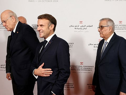 France's President Emmanuel Macron (C) reacts next to Lebanon's Prime Minister Najib Mikati (L) and Lebanon's Foreign Affairs Minister Abdallah Bou Habib (R) as they arrive for an international press conference in support of Lebanon, in Paris on October 24, 2024. 