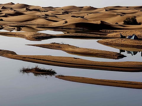 Tourists camp on the shores of Erg Znaigui, a seasonal lake in the village of Merzouga in the Sahara desert in southeastern Morocco.