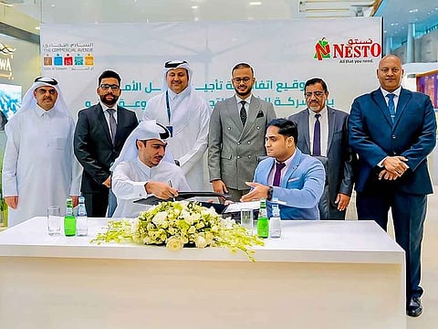 Sandeep Rajagopal, Head of Project & Infrastructure at Nesto Group, and Abdulla Abdulrazaiq Haidar, CEO of The Commercial Avenue, formalize the agreement, marking the beginning of a strategic partnership.