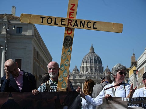 Activists of Ending Child Abuse (ECA) hold a protest against paedophilia within the Catholic Church ahead of Papal Synod in Rome with the Vatican in the background.