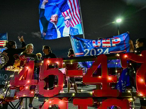 Supporters of former US president and Republican presidential candidate Donald Trump gather to show their support near his residence at Mar-a-Lago in West Palm Beach, Florida, on October 28, 2024.  