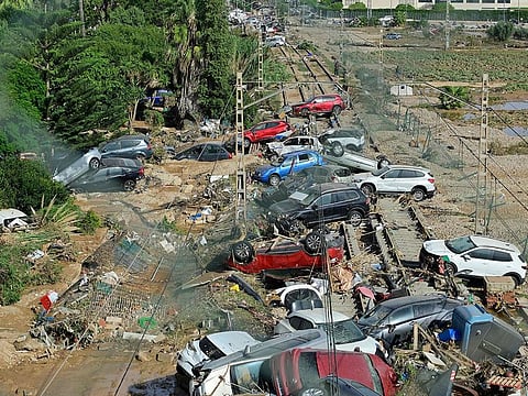 Wreckage of cars pile up on the on the railway on October 31, 2024 after flash floods ravaged the town of Alfafar, in the region of Valencia, eastern Spain.