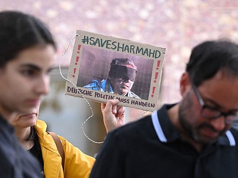 A demonstrator holds a picture of Iranian-German Jamshid Sharmahd, who has been executed in Iran.