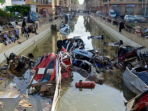 Wreckage of cars remain submerged in the water on October 31, 2024 after flash floods affected the town of Alfafar, in the region of Valencia, eastern Spain. Rescuers raced on October 31, 2024 to find survivors and victims of once-in-a-generation floods in Spain that killed at least 95 people and left towns submerged in a muddy deluge with overturned cars scattered in the streets. About 1,000 troops joined police and firefighters in the grim search for bodies in the Valencia region as Spain started three days of mourning. Up to a year's rain fell in a few hours on the eastern city of Valencia and surrounding region on October 29 sending torrents of water and mud through towns and cities.  