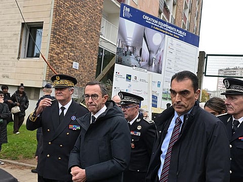 France's Minister of the Interior Bruno Retailleau (C) is surrounded by officials during a visit focused on drug trafficking in Rennes, western France on November 1, 2024. 