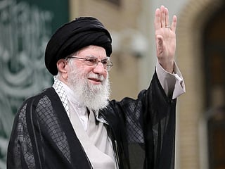 A handout picture provided by the office of Iran's supreme leader Ayatollah Ali Khamenei on November 2, 2024, shows him waving to the crowd during a meeting with Iranian students in Tehran. Khamenei vowed to respond to attacks on Iran and its allies.   
