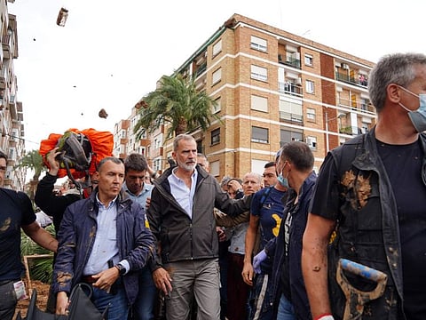 King Felipe VI of Spain (centre) is heckled by angry residents who throw mud and objects during his visit to Paiporta, in the region of Valencia, eastern Spain, on November 3, 2024.