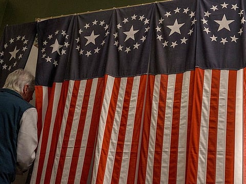 Les Otten casts the first of six ballots after the polls open on November 5, 2024 in Dixville Notch, New Hampshire. 