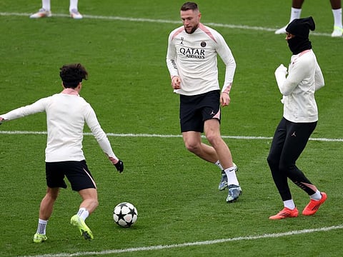 Paris Saint-Germain's Milan Skriniar (centre) vies with Vitinha (left) during a training session on the eve of the Uefa Champions League match against Atletico Madrid in Paris on Tuesday.