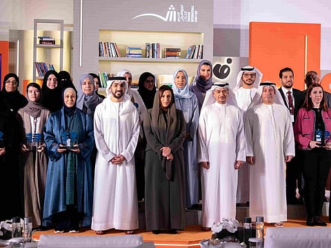Sheikha Bodour Al Qasimi standing for a photograph with graduates of first publishing cohort during the ceremony