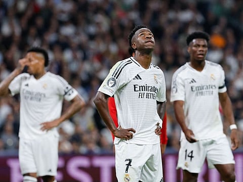 Real Madrid's Vinicius Junior (centre) reacts after AC Milan scored their second goal during their Uefa Champions League match in Madrid on Tuesday.