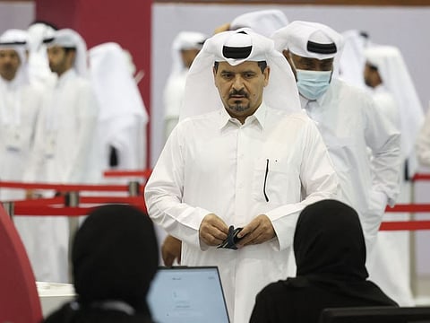 Qatari voters register at a polling station in Doha to take part in a general referendum on constitutional amendments, including scrapping legislative council elections, on November 5, 2024.  