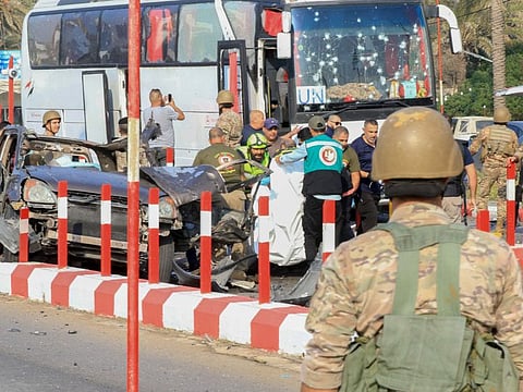 First aid responders and Lebanese soldiers gather at the site of an Israeli strike on a car at the northern entrance of the southern city of Sidon, on November 7, 2024.