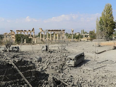 This picture shows damaged cars and debris at the site of an Israeli airstrike that targeted Baalbek in Lebanon's eastern Bekaa Valley overnight, with the ancient city's Roman temple in the background on November 7, 2024.