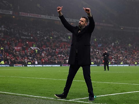 Manchester United's coach Ruud van Nistelrooy acknowledges fans at the end of the English Premier League football match against Leicester City at Old Trafford in Manchester, north west England, on Sunday.