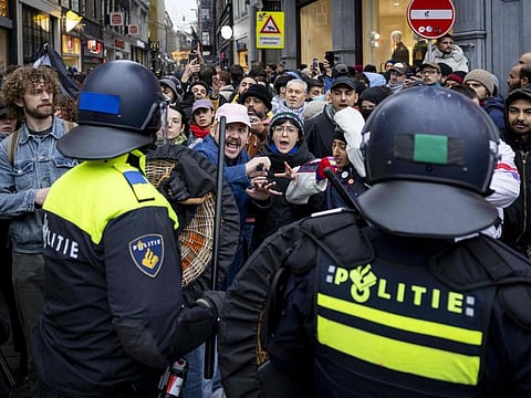 Police officers clear people away from Dam Square during a pro-Palestinian protest in Amsterdam on November 10, 2024.  