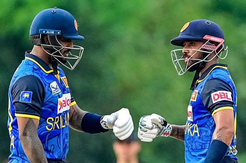 Sri Lanka's Kusal Mendis (right) and Avishka Fernando bump their fists during the first One-Day International cricket match against New Zealand at the Rangiri Dambulla International Stadium in Dambulla on Wednesday.