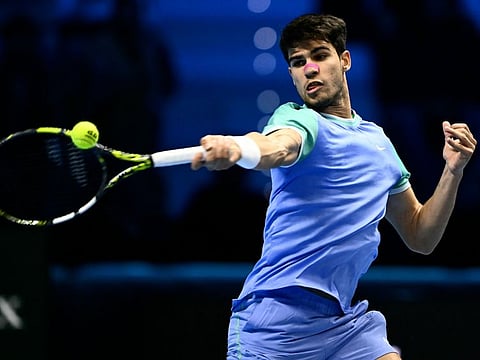 Spain's Carlos Alcaraz hits a return to Russia's Andrey Rublev during their match at the ATP Finals tennis tournament in Turin on Wednesday.