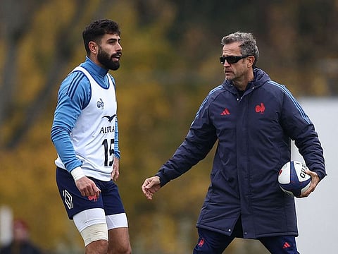 France's head coach Fabien Galthie (right) guides full back Romain Buros during a training session in Marcoussis, south of Paris, on Wednesday.