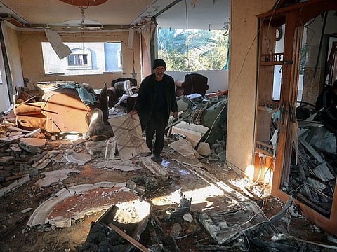 A man walks in a heavily damaged building following an Israeli strike in Deir Al Balah in the central Gaza Strip on November 15, 2024, amid the ongoing war between Israel and the Palestinian Hamas militant group.  