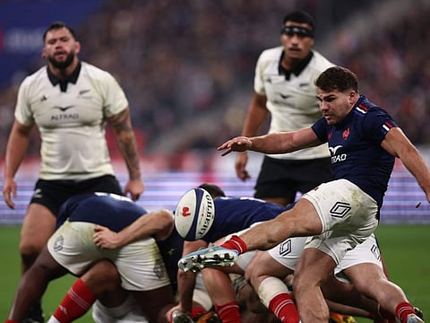 France's scrum-half and captain Antoine Dupont (right) clears the ball from a ruck during the Autumn Nations Series international rugby union test match against New Zealand at the Stade de France in Saint-Denis, north of Paris, on Saturday.