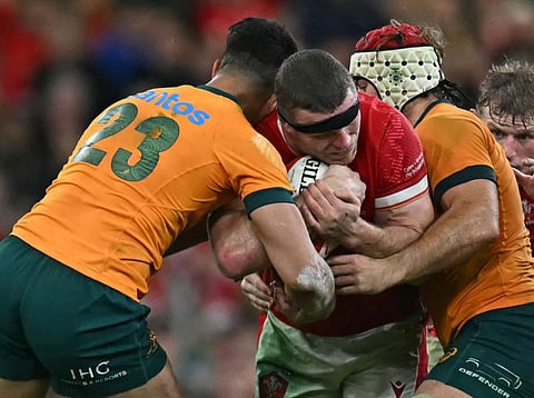 Wales' lock Will Rowlands (centre) is tackled by Australia's Joseph-Aukuso Suaalii (left) and flanker Fraser McReight during the Autumn Nations Series International rugby union test match at the Principality Stadium, in Cardiff on Sunday.