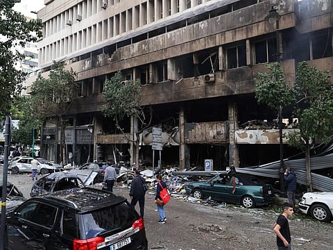 People inspect the damage to a building, targeted in an Israeli airstrike the previous day, in Beiruts Mar Elias Street on November 18, 2024.