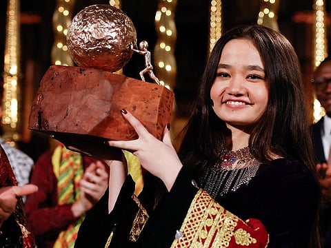Nila Ibrahimi, a 17-year-old Afghanistan-native girls' right activist, holds her prize after winning the KidsRights International Children's Peace Prize during a ceremony at De Nieuwe Kerk, in Amsterdam, on November 19, 2024. 