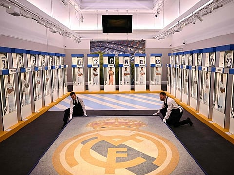 Sotheby's Members of staff arrange the mosaic from Santiago Bernabeu Stadium in Madrid, in a room displaying Real Madrids first-team changing room lockers, during the auction press preview, at Sotheby's auction house, in central London, on Wednesday.
