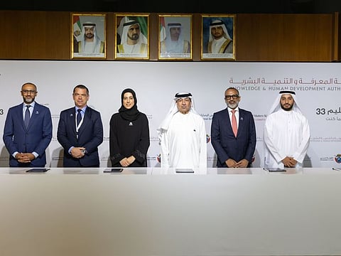 KHDA officials and school representatives standing of a photo during the ceremony to announce the Excel Anywhere programme in Dubai. 