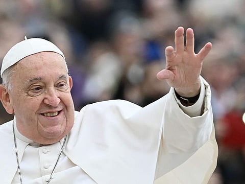 Pope Francis waves to the crowd during the weekly general audience at St Peter's Square in The Vatican on November 20, 2024.  