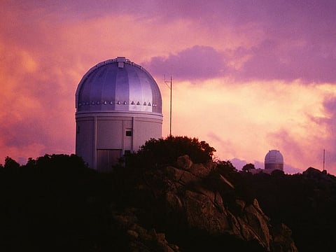 The Dark Energy Spectroscopic Instrument at Kitt Peak National Observatory (above) in Arizona, which can capture light from 5,000 galaxies simultaneously. 
