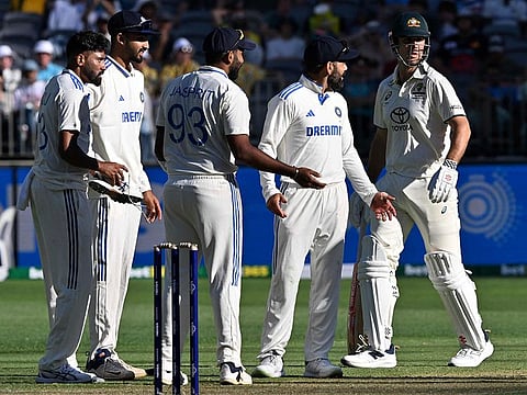 India's Viral Kohli (C) and Jasprit Bumrah (2nd L) argue with the umpire on the dismissal of Australia's Mitchell Marsh during the first day of the first Test cricket match between Australia and India at the Optus Stadium in Perth on November 22, 2024