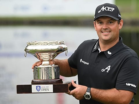 Patrick Reed of the US holds the trophy after winning the Hong Kong Open at Fanling golf club in Hong Kong on Sunday.