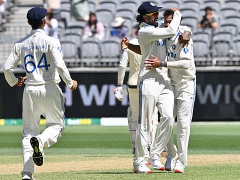 Indias Nitish Kumar Reddy celebrates his wicket of Australia's Mitchell Marsh with teammate KL Rahul on day four of the first Test cricket match at Optus Stadium in Perth on Monday.