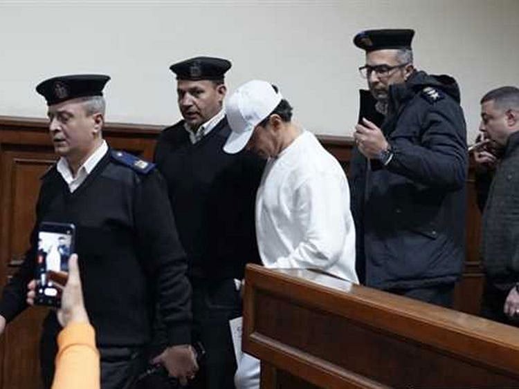 Al Soghayar is led by police during a trial hearing in Cairo. 