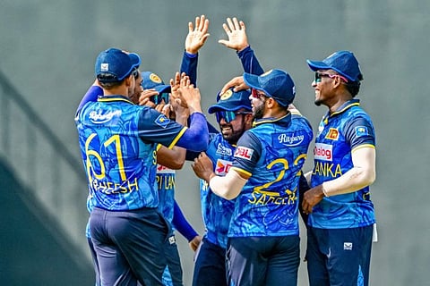 Sri Lanka's captain Charith Asalanka (centre) celebrates with teammates after taking a catch to dismiss New Zealand's Tim Robinson during the third and final One-Day International cricket match at the Pallekele International Cricket Stadium in Kandy on November 19.