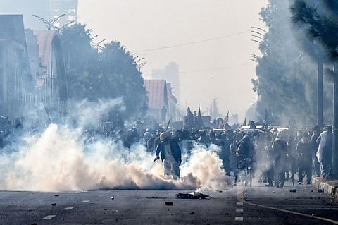 Policemen fire tear gas shells to disperse supporters of the Pakistan Tehreek-e-Insaf (PTI) party during a protest demanding the release of former prime minister Imran Khan, at the Red Zone area in Islamabad on November 26, 2024.  